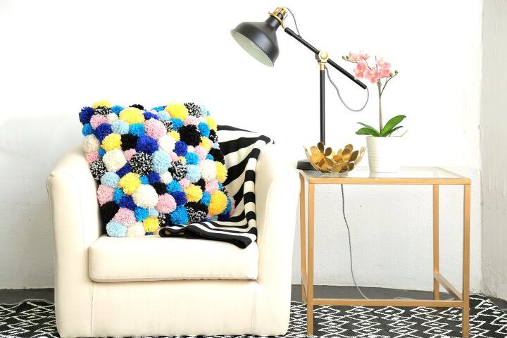 s 13 cool pillow ideas that ll make it feel like you bought a new couch, Make a cozy pom pom accent pillow