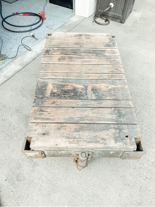 how to restore an old railroad cart into a coffee table, Here you can really see the black paint shining through on the tabletop