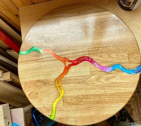 rainbow river of melted crayons on coffee wooden table