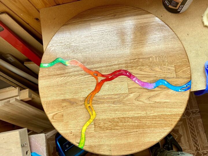 rainbow river of melted crayons on coffee wooden table