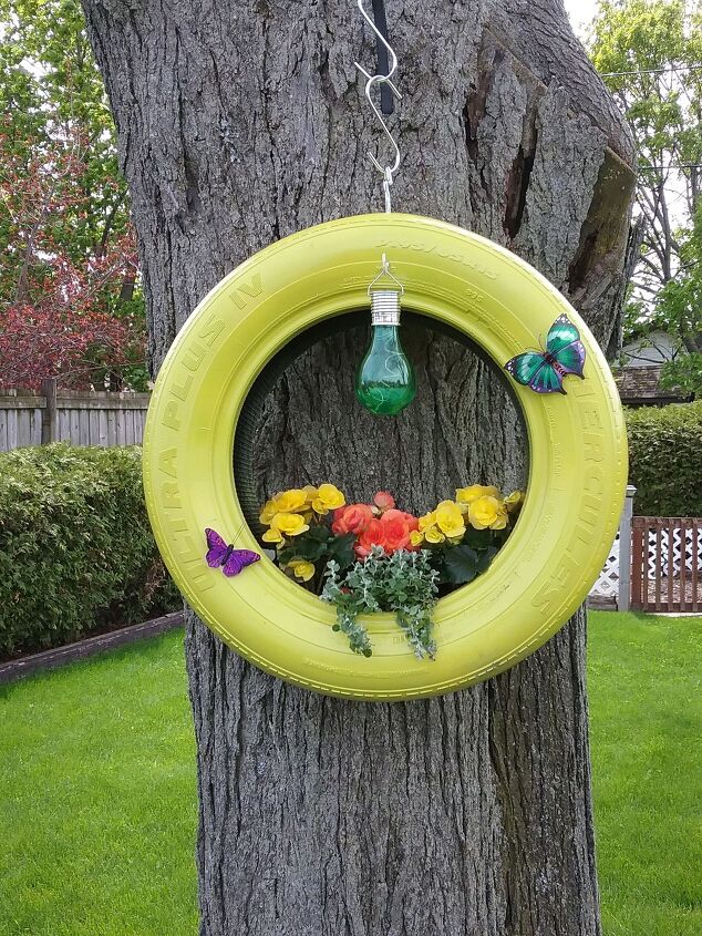 25 spring porch ideas that ll brighten up your block, Decorated hanging tire planter