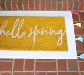 25 spring porch ideas that ll brighten up your block, No sew tasseled drop cloth layering rug