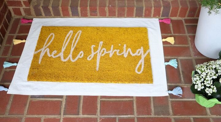 25 spring porch ideas that ll brighten up your block, No sew tasseled drop cloth layering rug