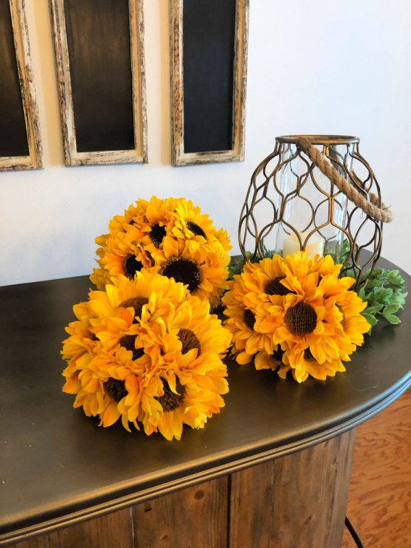 s 15 stunning ways to spruce up your mantel this month, Place bright sunflower ball decor