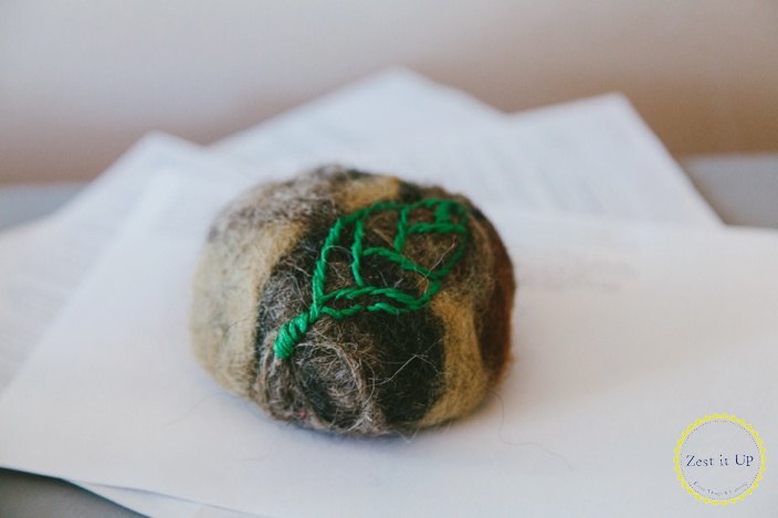 s 20 creative ways to give your home a boho vibe, Embroider a rock for a uniquely earthy paperweight