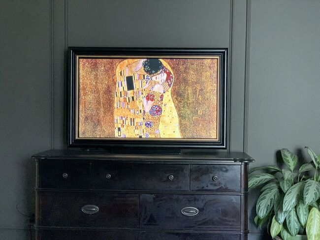 DIY TV frame displaying art over a dresser