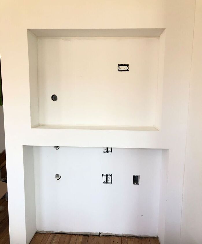 see how we added warmth with a diy wood shim accent wall, Before shot of TV niche