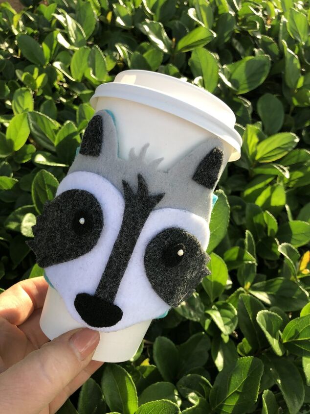 s 20 smart diys that are getting coffee lovers really excited, A sweet woodland raccoon coffee cozy