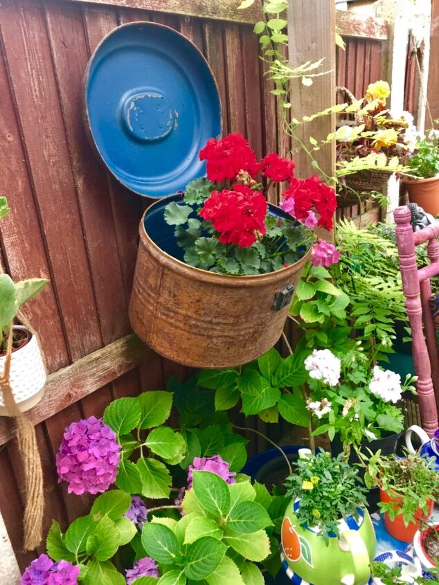 20 whimsical garden ideas that ll make your neighbors stop and stare, A delightful metal hatbox planter