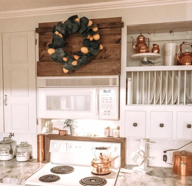 12 stunning ways to fill the space above your stove, Install an dark espresso stained vent hood