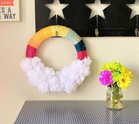 s make your space a cheery haven with 15 pom pom diys, A rainbow wreath with chunky yarn