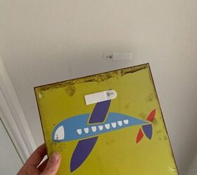 This mom sticks velcro on a cheap, wooden picture to get instant farmhouse decor