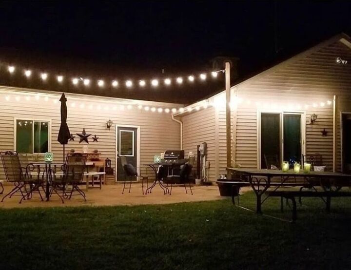 how to make diy string light metal posts, The patio lit up with string lights