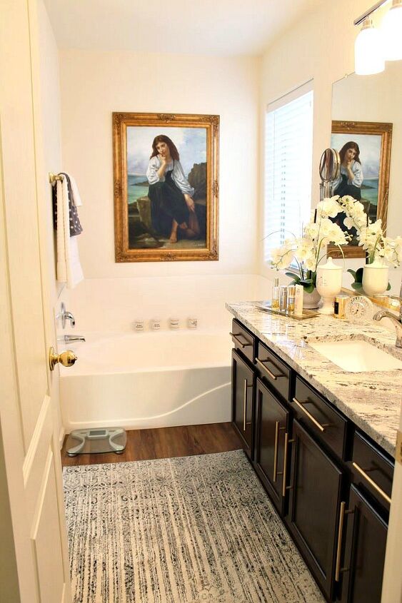 s 17 small bathroom upgrades that make a huge difference, Hang a gold framed painting