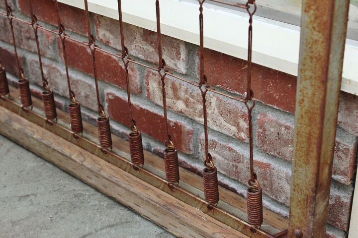 a rusty bed spring becomes a trellis