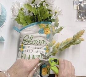 make your oven mitt into a beautiful floral bouquet, Next stick the fake flowers into the mitt making sure to pierce the tissue paper In addition if any flower stems are too long trim them down