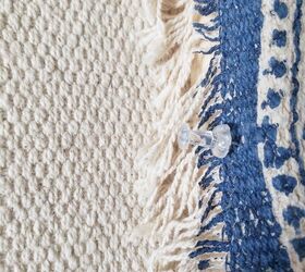 Use thumbtacks and fabric (a rug will work!) to copy this high-end idea
