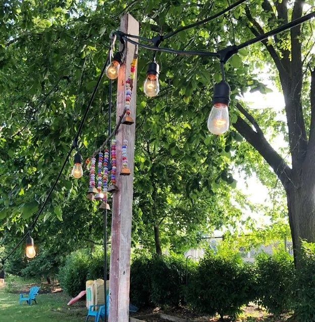 s 15 creative ways to light up your yard this summer, Useful planter string light posts