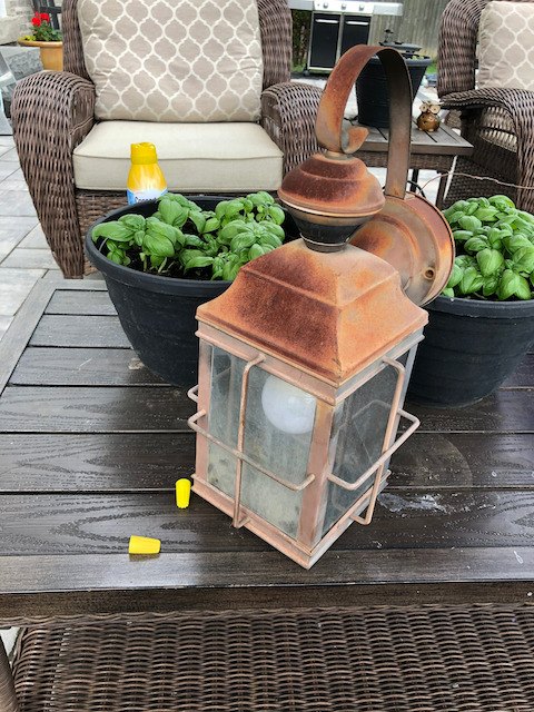 rusty and broken old exterior light fixture vs spray paint and a scre