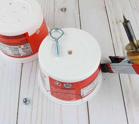 She hangs 2 plastic containers in her tree to create a beautiful & functional garden accent