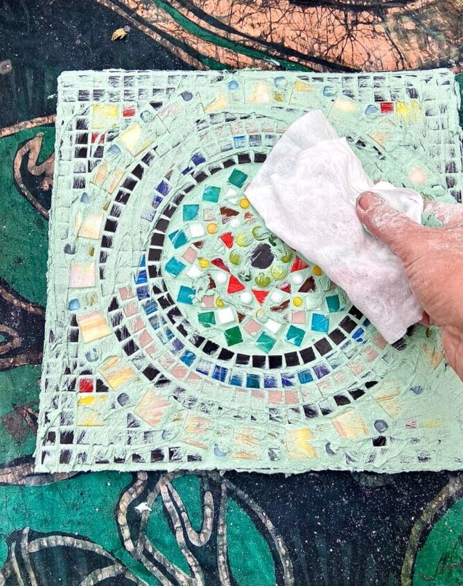 how to create a mosaic mandala for your garden, Wipe excess grout off