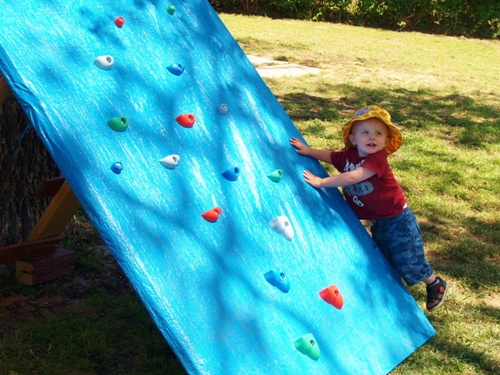 s 25 backyard ideas that ll make your kids summer, A tarp covered climbing wall