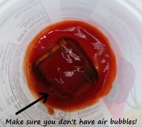 Squeeze ketchup into a cup for the easiest cleaning hack yet