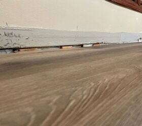 use caulking fill floor gaps and liquid nails to re adhere baseboards