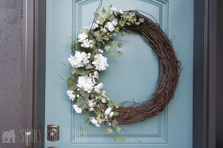 s 15 awesome summer wreaths that will make your front door look so cute, A simple white floral wreath