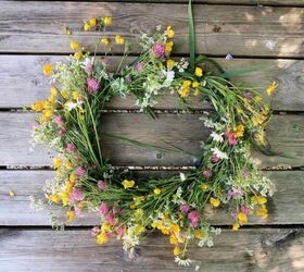 s 15 awesome summer wreaths that will make your front door look so cute, A pretty wildflower wreath