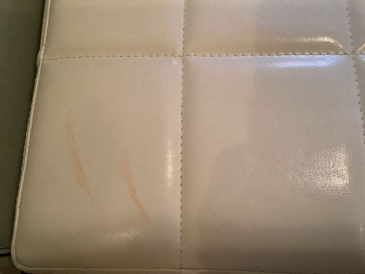 q how do i remove a food stain from a white faux leather footstool