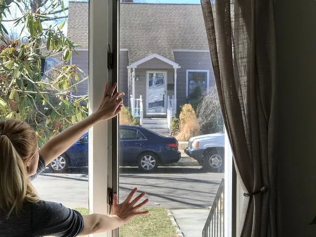 how to clean window screens like a pro, woman pushing window closed
