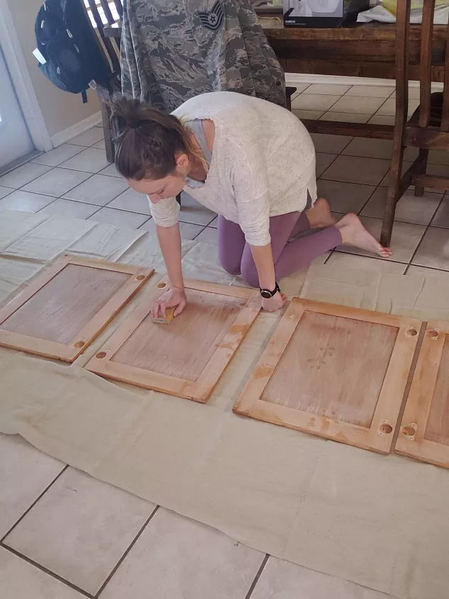 our best tips and tricks on how to paint kitchen cabinets, bare kitchen cabinets laid on ground