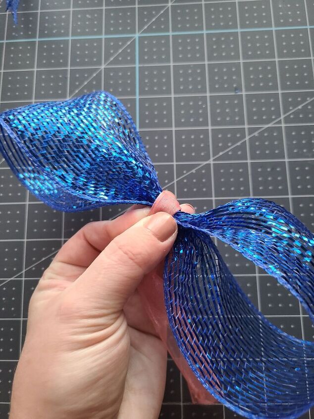 , Hot glue the end on the back of the bow and cut off the excess ribbon