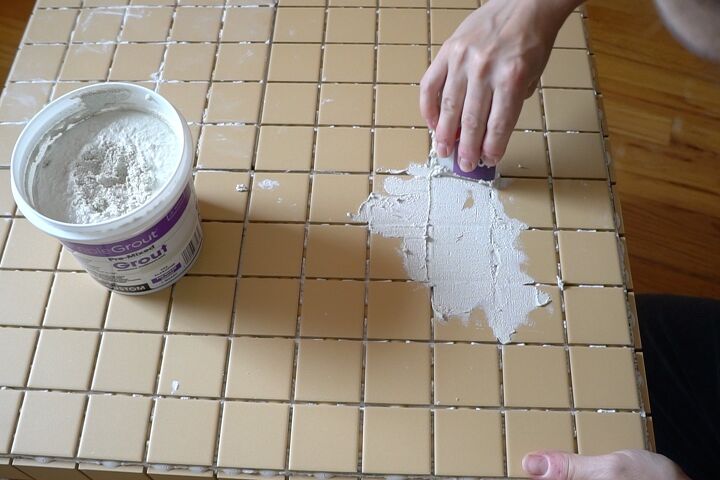 diy tile table as seen on tiktok, I used an old credit card to apply the grout