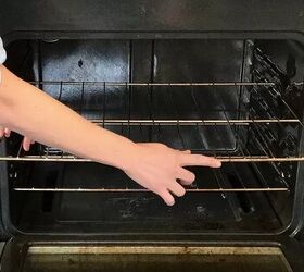 how to clean an oven inside and out, hands removing racks from oven