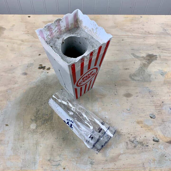 um vaso de cimento diy com um design de gato