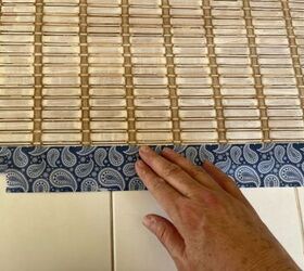 She presses duct tape along the bottom of her window blinds for this brilliant bedroom floor idea