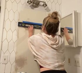 faux tile with a paint pen arches budget bathroom makeover part 1, Making sure tape is level