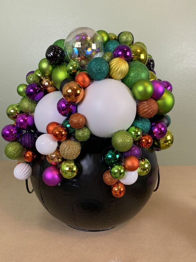 s grab a trash bag and googly eyes for these creepy halloween ideas, Her sparkly ornament cauldron