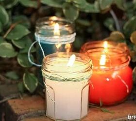 4 hacks for how to clean out a candle jar, three lit candles in front of greenery