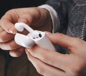 how to clean airpods in a few steps, fingers taking airpods out of case