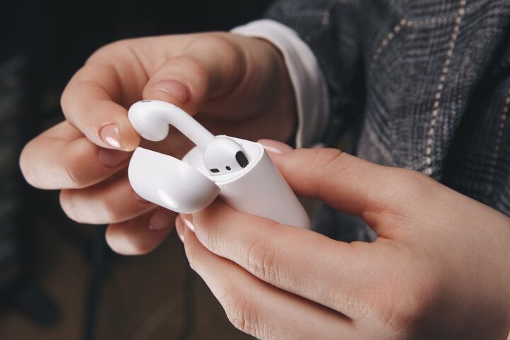 how to clean airpods in a few steps, fingers taking airpods out of case