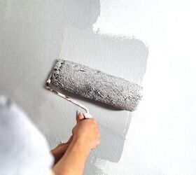 a step by step guide on how to paint a room, Gray paint rolling over wall