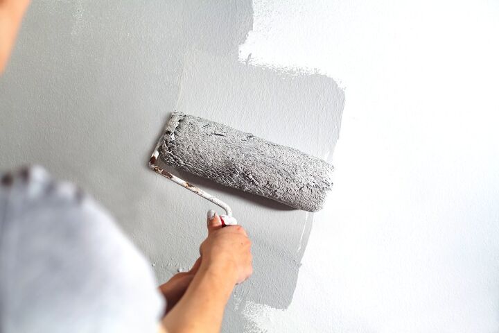 a step by step guide on how to paint a room, Gray paint rolling over wall