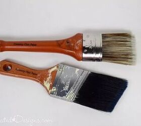 a step by step guide on how to paint a room, Two wood handled paint brushes laying on a white surface