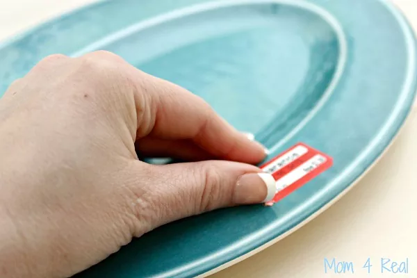how to remove sticker residue from any surface, hand removing sticker from plate