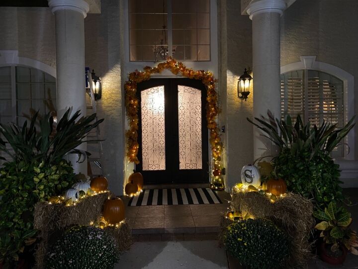 fall door decor using hay bales and fairy lights