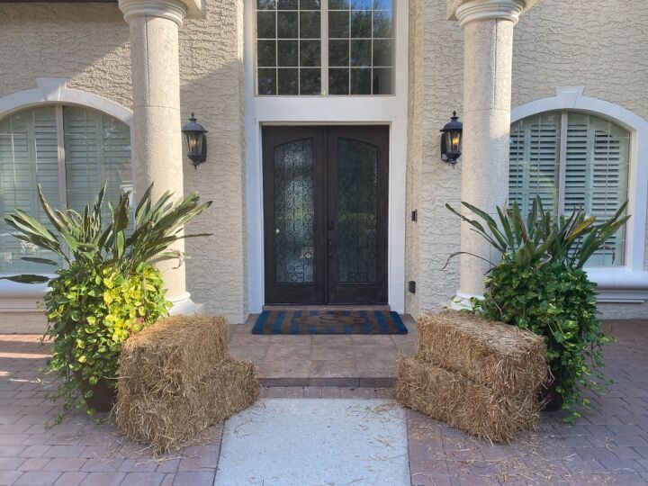 fall door decor using hay bales and fairy lights