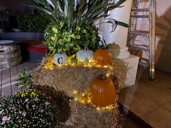 fall door decor using hay bales and fairy lights